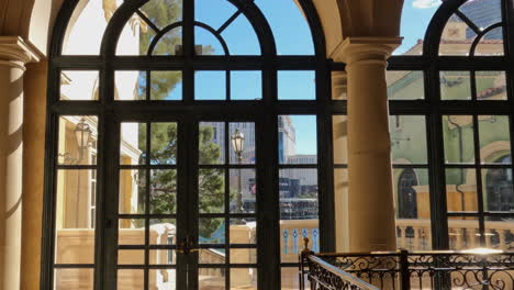 Las-Vegas-USA,-Walking-to-Glass-Doors-and-Terrace-Inside-Bellagio-Casino-Hotel-on-Sunny-Day