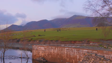 People-walking-near-the-water-and-ducks-in-the-lake-district-of-Cumbria