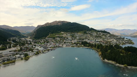 Wide,-establishing-aerial-view-overlooking-Queenstown-downtown-and-bay,-New-Zealand