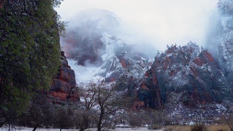 A-Reveal-shot-of-the-cloud-covered-mountains-in-on-a-snowy-winter-day-in-Zion-National-Park