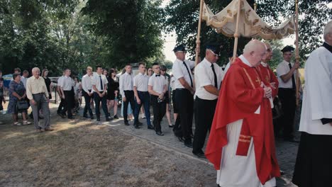 Procession,-believers-walk-around-the-church-in-the-countryside