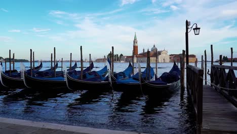 Gondola-boats-lined-up-in-front-of-an-island