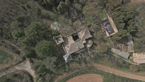 Descending-tilt-down-shot-turning-left-over-Castle-of-Perafita,-in-Catalonia,-Spain