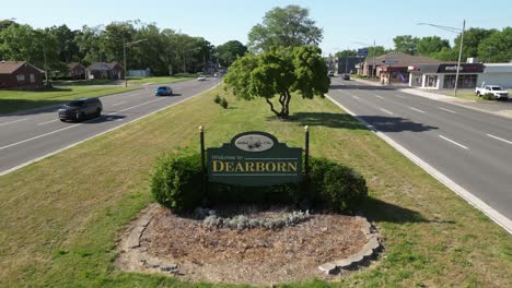 Welcome-to-Dearborn,-Michigan-sign-with-drone-video-pulling-back