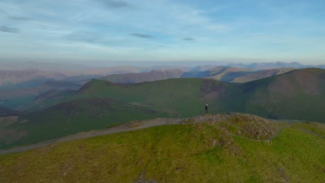 Lone-mountain-walker-on-fell-path-summit-at-golden-hour