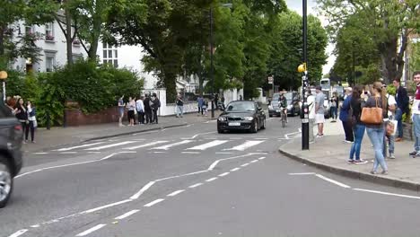 Tourists-posing-on-Abbey-Road-zebra-crossing-made-famous-by-the-Beatles-album-cover-"Abbey-Road"-in-1969