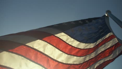 Closeup-of-USA-American-flag-flying-in-small-town-for-4th-of-July