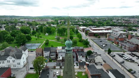 Cross-on-top-of-ancient-church-in-American-town