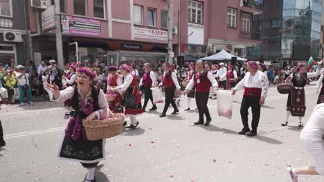 Bulgarian-costumed-women-throw-rose-petals-at-cheering-festival-crowds