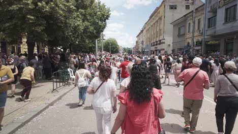 Walking-with-international-crowds-of-people-along-main-street-POV-Slow-motion