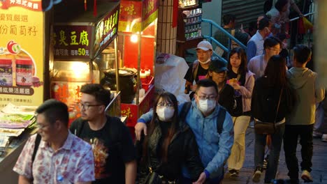 People-thronging-the-narrow-laneway-of-Jiufen-Old-Street,-a-captivating-Taiwan-mountain-village,-exploring-the-vibrant-food-stalls,-souvenir-shops,-and-eclectic-gift-boutiques