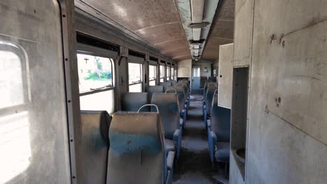 View-Of-An-Abandoned-Train-From-The-Inside-In-Peloponnese,-Greece---Panning-Shot