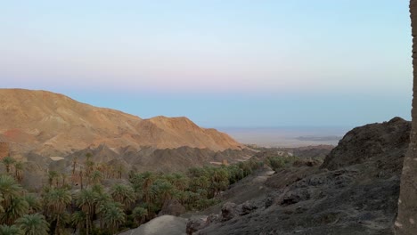 Morocco-rural-life-historical-landscape-of-date-palm-grove-terraced-garden-in-mountain-desert-wide-view-panoramic-landscape-of-evening-from-the-high-mud-brick-clay-house-cube-architecture-design-Iran