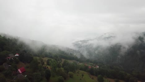 Stunning-drone-shot-of-the-misty-Carpathian-mountains-in-Matisesti,-Romania