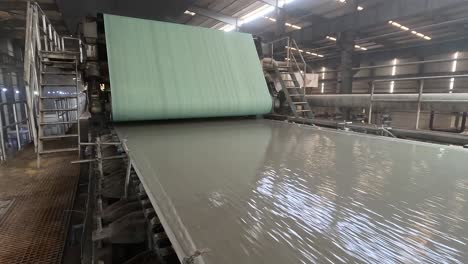 Inside-the-big-machine,-the-paper-is-being-prepared-and-wrapped-inside-the-roll