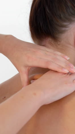 Side-view-of-woman-therapist-massaging-the-back-of-her-patient