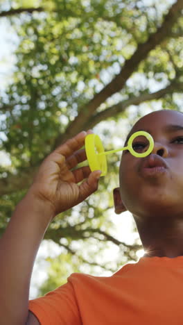 Young-boy-blowing-bubbles-through-bubble-wand