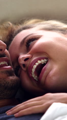 Cute-couple-laughing-in-bed