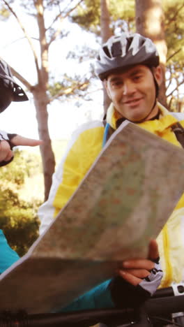 Mountain-biking-couple-looking-at-map