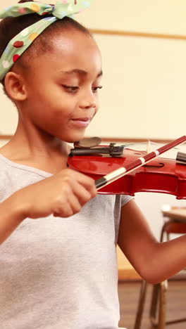 Cute-pupil-playing-violin-in-classroom