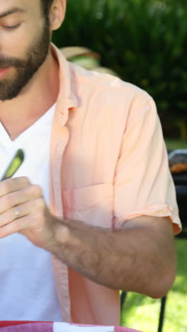 Portrait-of-happy-father-is-eating-with-his-family-in-the-garden