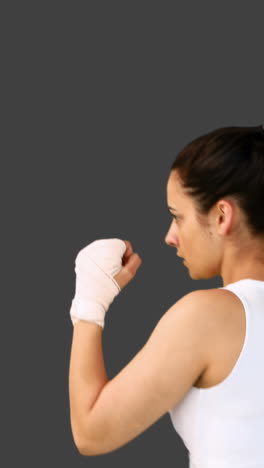 Fit-brunette-punching-with-bandaged-fists