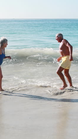 Old-retired-couple-playing-in-the-sea