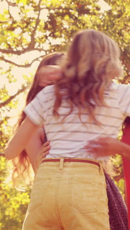 Happy-female-friends-talking-and-laughing-together-in-the-park