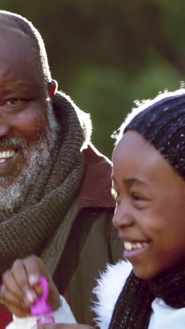 Grandfather-and-girl-blowing-bubbles