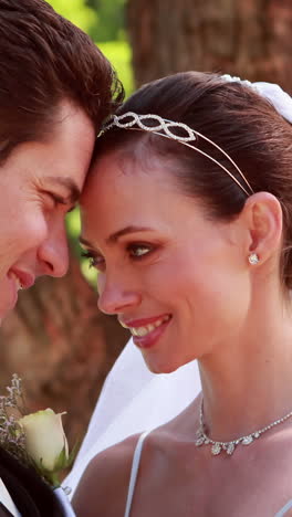 Happy-newlyweds-hugging-and-smiling-at-camera