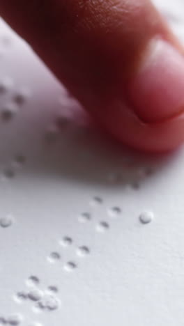 School-kid-reading-a-braille-book-in-classroom-at-school