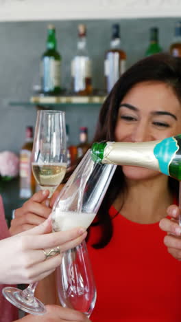 Man-serving-champagne-to-his-friends