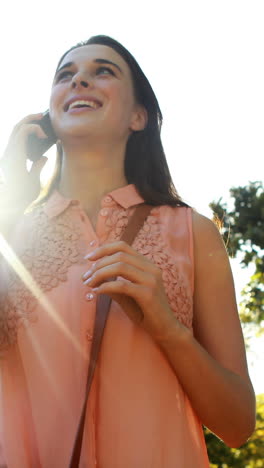 Woman-talking-on-phone-in-park