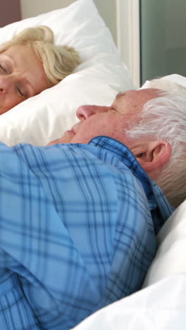 Senior-couple-sleeping-in-bed