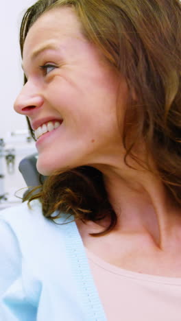 Patient-checking-her-teeth-in-mirror