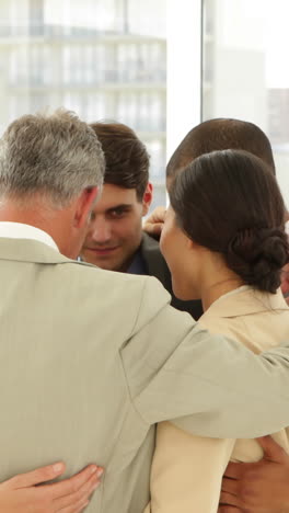 Business-people-hugging-each-other-in-a-circle