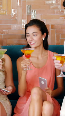 Two-men-giving-cocktail-drink-to-women