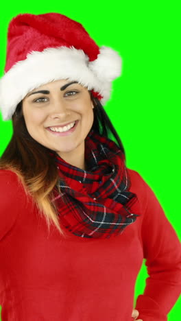 Festive-brunette-in-santa-hat-blowing-over-hands