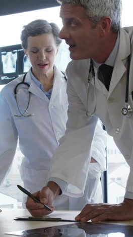 Doctors-looking-together-a-document