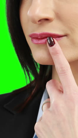 Businesswoman-putting-her-finger-on-her-lips