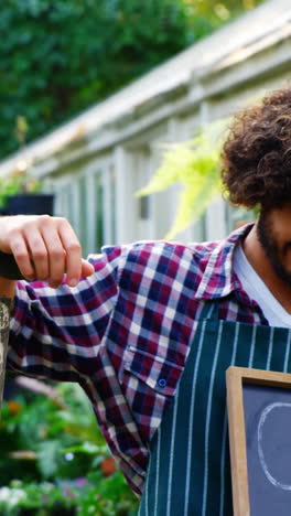 Gardener-holding-open-sign