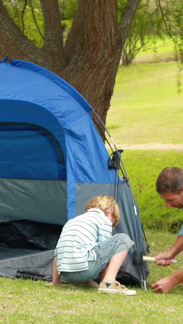 Father-and-son-preparing-their-tent-