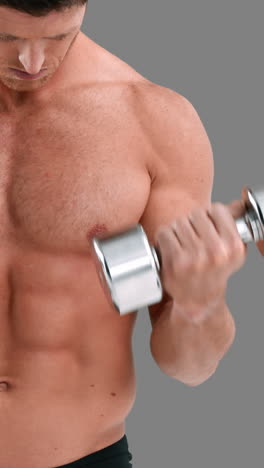 Serious-muscular-man-lifting-dumbbells-