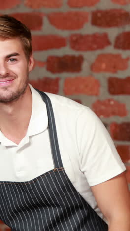 Smiling-waiter-tiding-up-the-counter