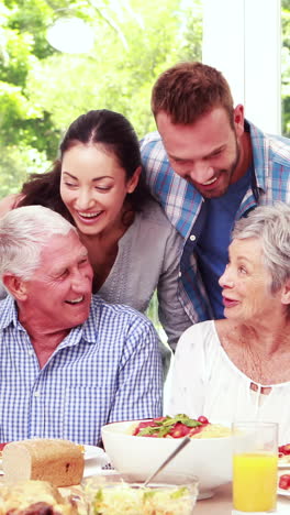 Happy-family-posing-during-lunch-