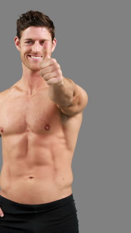 Muscular-man-with-thumbs-up-posing-