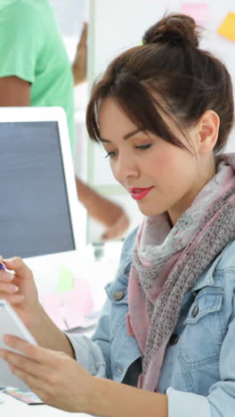 Cute-creative-designer-working-sitting-at-her-desk-