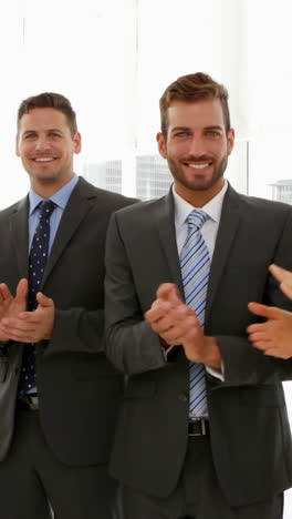 Business-people-clapping-at-the-camera