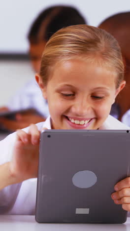 Schoolgirl-using-digital-tablet-in-classroom