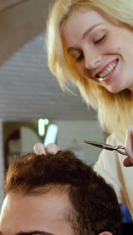 Man-getting-his-hair-trimmed-with-scissor